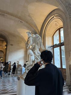 a man standing in front of a statue