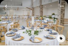 the tables are set with blue napkins and place settings for guests to sit at