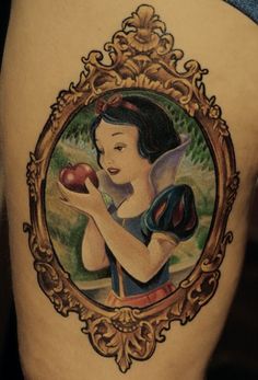 a girl with an apple in her hand is depicted on the side of a woman's thigh