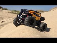 a monster truck driving through the sand dunes