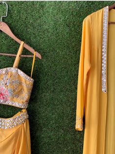 This playful printed yellow bustier paired with a cowl skirt and jacket with printed ruffles at the hem is a must have in your wardrobe for any occasion. Spring Georgette Sets With Traditional Drape, Summer Party Georgette Sets, Elegant Fitted Yellow Choli, Yellow Dresses For Designer Wear In Spring, Fitted Skirt Set For Festive Summer Occasion, Fitted Skirt Set For Summer Festivities, Designer Spring Party Wear Sets, Yellow Georgette Party Wear Set, Fitted Festive Skirt Set For Summer