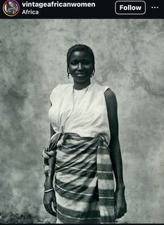 an old photo of a woman standing in front of a wall with the words vintage african women follow