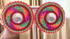 Swirl design beaded earrings. Pearl center surrounded by beautiful red , orange, pink, green, and purple beads. As well as rhinestone banding Chino Hills, Purple Beads, Earrings Pearl, Swirl Design, Orange Pink, Jewelry Earrings Studs, Green And Purple, Beaded Earrings, Swirl