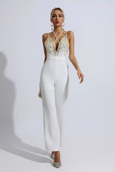 The Matilda White Sequin Embellished Jumpsuit will be your luxurious piece, the perfect expression of elegance, making you the ultimate highlight. Refreshing your wardrobe with a chic halter neck and deep V-neck detailing, this piece sparkles with sequin and crystal stone accents, while spaghetti straps add a touch of classic appeal. Make a bold statement in this stunning jumpsuit. Wear it with heels and a tote for an important event.Length: Approx 145cmMaterials: PolyesterGentle Dry Clean ... White Long Jumpsuit, Embellished Jumpsuit, Glitter Wedding Dress, 2023 Clothing, Bandage Midi Dress, Floral Shirt Dress, Jumpsuit Party, Puff Sleeve Dresses, White Jumpsuit