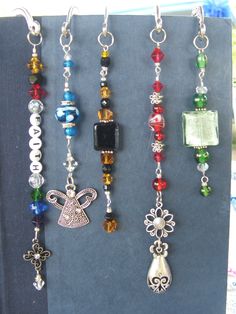 several different types of beaded necklaces hanging from hooks