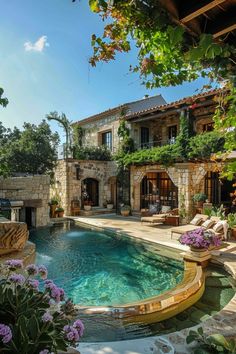 an outdoor swimming pool surrounded by greenery and stone walls, with chairs around it