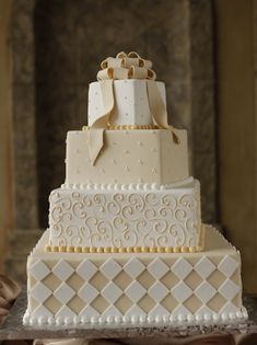 a three tiered wedding cake with bows on top