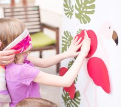 two children and an adult are playing with magnets on a board outside in the grass