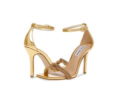 Steve Madden Confeti Heeled Sandal - Women's Shoes : Gold : Get ready to jazz up your outfit wearing the super-sleek and chic Steve Madden Confeti Heeled Sandals. Synthetic upper with intertwined jewel-encrusted toe straps. Synthetic lining and insole. Adjustable buckle closure on the ankle strap. Square open toe. High stiletto heel. Metallic detailing. Synthetic outsole. Imported. Measurements: Heel Height: 4 in. Elegant Adjustable Heels With Heel Loop, Adjustable Evening Sandals, Elegant Adjustable Strappy Sandals, Formal Strappy Sandals With Rhinestones, Gold Strap Sandals For Evening, Gold Strap Sandals For Formal Occasions, Glamorous Spring Sandals With Chain Strap, Glamorous Strappy Sandals, Elegant Adjustable Sandals For Evening