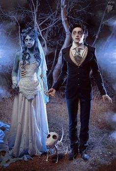 a couple dressed up as corpse bride and groom holding hands in front of a spooky forest