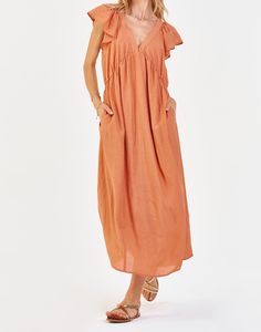 image of a female model wearing a LOTTIE DEEP V DRESS SOFT APRICOT DEAR JOHN DENIM Beach V-neck Ruffled Maxi Dress, V-neck Maxi Dress With Pockets For Daywear, Maxi Length V-neck Ruffled Beach Dress, Beach V-neck Maxi Dress With Ruffles, Beach V-neck Ruffle Maxi Dress, Summer Maxi Dress With Pockets And V-neck, V-neck Maxi Summer Dress With Pockets, V-neck Maxi Dress With Pockets For Summer, Summer V-neck Maxi Dress With Pockets