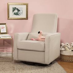 a chair with a stuffed animal on top of it in front of a pink wall