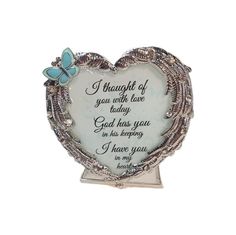 a heart shaped glass plaque with a poem on the side and a blue butterfly sitting in it