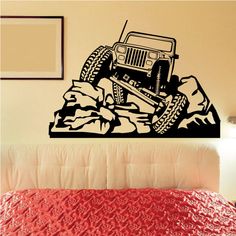 a black and white wall decal of a jeep driving over rocks