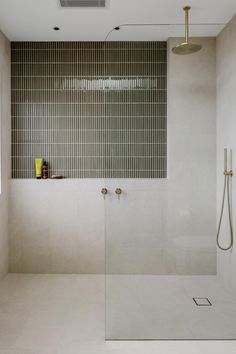 a bathroom with a shower and tiled walls