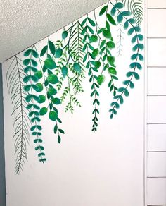 some green leaves are hanging on the wall