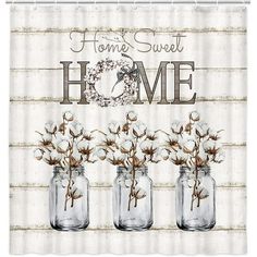 three mason jars with cotton flowers in them and the words home sweet home