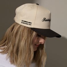 Make sure everyone knows you have a little bit of a wild side with our Raising Hell Trucker Hat. This two-tone hat features a charcoal bill and a tan canvas material all around the hat. This is far from your average snapback hat, we made sure the design is fully embroidered and there’s an added detail on the side reading “Uncommon James established 2017.” Want a full look? Get our Raising Hell Sweatshirt. Trucker Hats Western, Affordable Western Snapback Trucker Hat, Outdoor Graphic Print Snapback Trucker Hat, Brown Western Trucker Hat, Western-themed Snapback Trucker Hat, Snapback Hats, Tequila, Black Color, Hoodies Womens