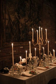 a long table with candles and flowers on it