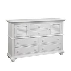 a white dresser with shutters on the top and bottom drawers, against a white background