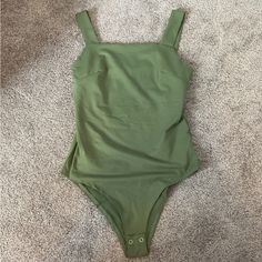 Beautiful Green Bodysuit With Snaps At The Bottom. The Material On This Is So Soft And Stretchy! Perfect To Match All Your Cute Shorts And Skirts! Green Sleeveless Bodysuit For Beach Season, Sleeveless Green Bodysuit For Beach Season, Chic Summer Bodysuit In Solid Color, Summer High Waisted Bodysuit For Day Out, High Waist Bodysuit For Summer Day Out, Summer High-waist Bodysuit For Day Out, Green Sleeveless Bodysuit For Summer, Chic Green Bodysuit For Beach Season, Chic Green Bodysuit For Summer