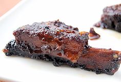 two pieces of chocolate cake sitting on top of a white plate next to each other