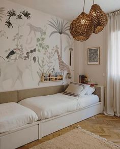 a bedroom with two twin beds and an animal mural on the wall