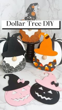 some paper pumpkins and other decorations on a marble surface with the words dollar tree diy