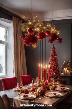 a dining room table decorated for christmas with red and gold decorations