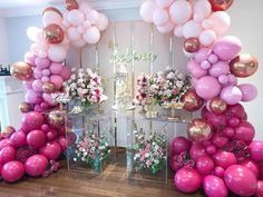 balloons and flowers are arranged in the shape of an arch