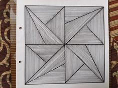 a piece of paper that has been drawn with lines on it, and is sitting on top of a table