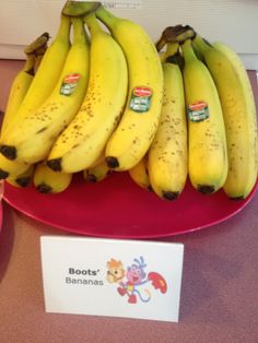 bunches of bananas are on a red plate