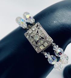 "This vintage bracelet has a double strand of auora borealis crystals. It has the most beautiful silvertone and rhinestone Art Deco style  feature clasp. It dates from the 1950's and is in excellent vintage condition. It measures 7.5\" in length." Adjustable Vintage Silver Crystal Bracelet, Vintage Silver Double Strand Jewelry, Vintage Crystal Bracelet For Wedding, Vintage Wedding Crystal Bracelet, Vintage Silver Jeweled Bracelets, Vintage Adjustable Crystal Bracelet For Party, Vintage Crystal Bracelets For Formal Occasions, Vintage Adjustable Jewelry With Sparkling Stones, Vintage Jeweled Crystal Bracelets