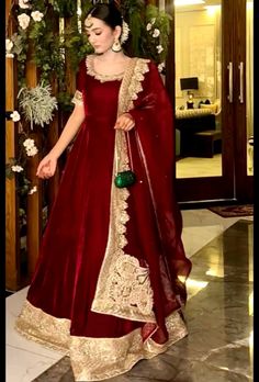 a woman in a red and gold gown