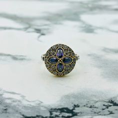 This piece is a quaint and chic 70's bohemian vintage jewelry style and has a certain sense of nostalgia to your fashion, it is the perfect casual and special event ting. The ring exhibits a beautiful anemone flower pattern, with four petals of amethyst stones mounted on a background of detailed with intricate oxidized , giving the illusion of depth and contrast to the design. To look aged, it has been subject to a method that adds patina, giving it a vintage look, which instantly makes it a pre Vintage Purple Crystal Ring, Bohemian Crystal Promise Ring Stamped 925, Bohemian Flower Promise Ring, Vintage Amethyst Jewelry With Rose Cut Diamonds, Bohemian Crystal Ring With Stone Setting, Vintage Silver Amethyst Ring With Stone Setting, Vintage Silver Flower Ring With Rose Cut Diamonds, Bohemian Silver Amethyst Ring, Vintage Gold Flower Ring In Sterling Silver