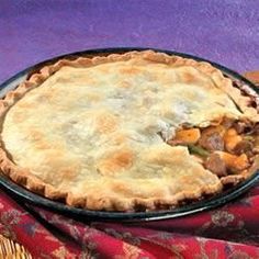 a pie sitting on top of a table next to a red and blue cloth covered tablecloth