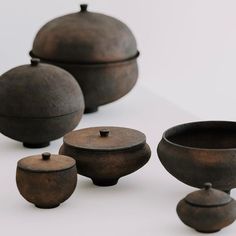 an assortment of pots and bowls sitting on a table