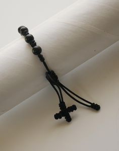 THIS BRACELET IS TO BE USED BY MEN or WOMEN. ADJUSTS FROM 7" - 9.5" This listing is for (1) Bracelet. BEADS: Beads have are made of wood and are round in shape. They measure approx. 1/4" in diameter. Beads are connected to the others with a cord. This is a very good quality and elegant rosary bracelet that you can use anytime of the day. Come Visit Us at Our New Store! Please feel free to email me with questions about this item. Also please check my other listings. I am always available to answer your questions promptly. Buy from us with confidence. Adjustable Black Wristband With 8mm Beads, Adjustable Handmade Black Rosary Bracelet, Adjustable Black Beaded Rosary Bracelet, Adjustable Black Leather Bracelet With Round Beads, Adjustable Black Cross Bracelet, Handmade Black Spiritual Leather Bracelet, Adjustable Black Spiritual Bracelet, Adjustable Beaded Cross Rosary Bracelet, Adjustable Beaded Cross Bracelet