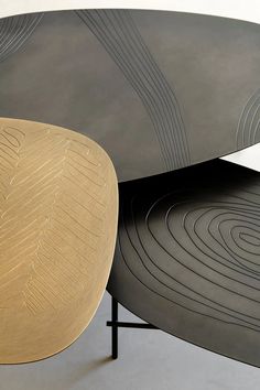 two tables that are next to each other with designs on the top and bottom one