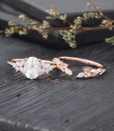 a close up of a ring on top of a wooden table with flowers in the background