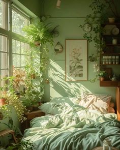 a bedroom with green walls and plants on the windowsill