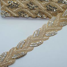 gold sequins and beaded trim on a white surface