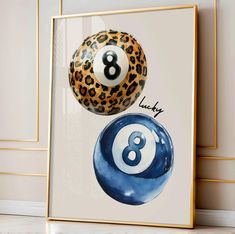 an image of two pool balls with the number eight on them in front of a white wall