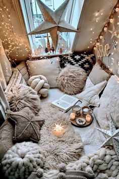 a room filled with lots of pillows and lights