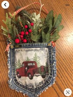 an old jean pocket with a red truck and evergreens in it