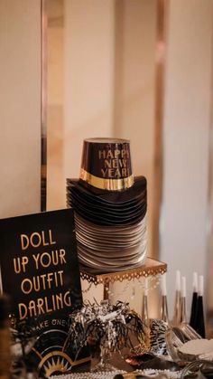 a table topped with lots of different types of plates and silverware next to a sign that says doll up your outfit daring