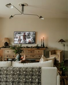 a living room filled with furniture and a flat screen tv mounted to the side of a wall