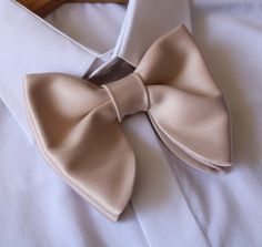 "Oversized Bow Tie in Champagne Beige Satin. Pre-tied and adjustable strap. Bow tie size - Width: 12 cm /4,7\"  | Height: 10 cm / 3.93'' The adjustable strap takes it to 21\" in length, making it a great accessory that can be adjusted for comfort and fit or given as a gift if you are unsure of neck size. Perfect for formal or causal use. **bowties are shipped in a small shipping box to keep them from being damaged**" Wedding Ties With Satin Bow Detail, Wedding Ties With Satin Bow, Elegant Wedding Ties With Ribbon Detail, Elegant Wedding Tie With Ribbon, Elegant Bow Tie With Adjustable Ties, Elegant Bow Tie With Adjustable Ties As Gift, Classic Pre-tied Bow For Wedding, Pre-tied Satin Bow Tie For Wedding, Adjustable Satin Bow Tie For Wedding