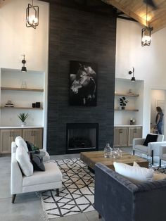 a living room filled with furniture and a fire place in the middle of a room