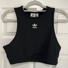 Nwt Adidas Tank Top. Black Ribbed Tank Top With White Embroidered Adidas Emblem On Front. Size Large. Small Cutout On Bottom. So Cute For Gym Or Every Day ! Brand New With All Tags Attached. Slightly Cropped Style Adidas Fitted Sleeveless Tank Top, Adidas Sleeveless Fitted Tank Top, Fitted Sleeveless Adidas Tank Top, Adidas Cotton Tank Top For Spring, Black Sports Crop Top For Spring, Adidas Fitted Tops For Streetwear, Adidas Fitted Streetwear Tops, Fitted Adidas Tops For Streetwear, Adidas Trendy Fitted Tops